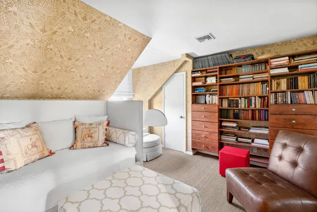 a bedroom with furniture and a book shelf