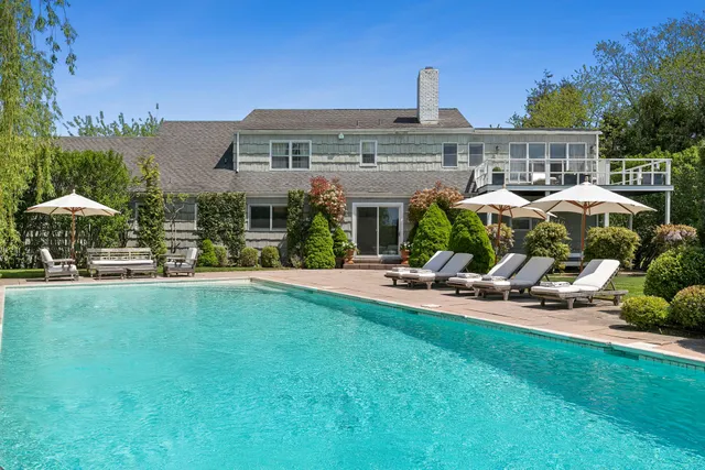 a view of a house with backyard sitting area and garden