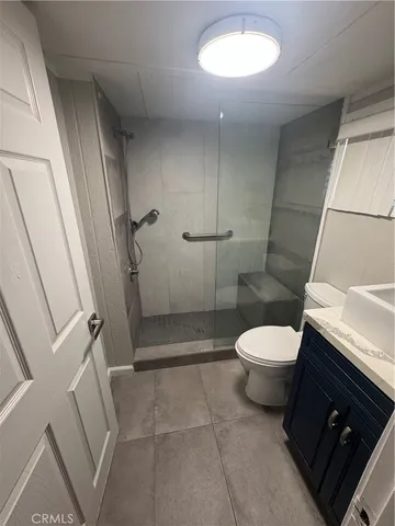 a bathroom with a toilet and a shower