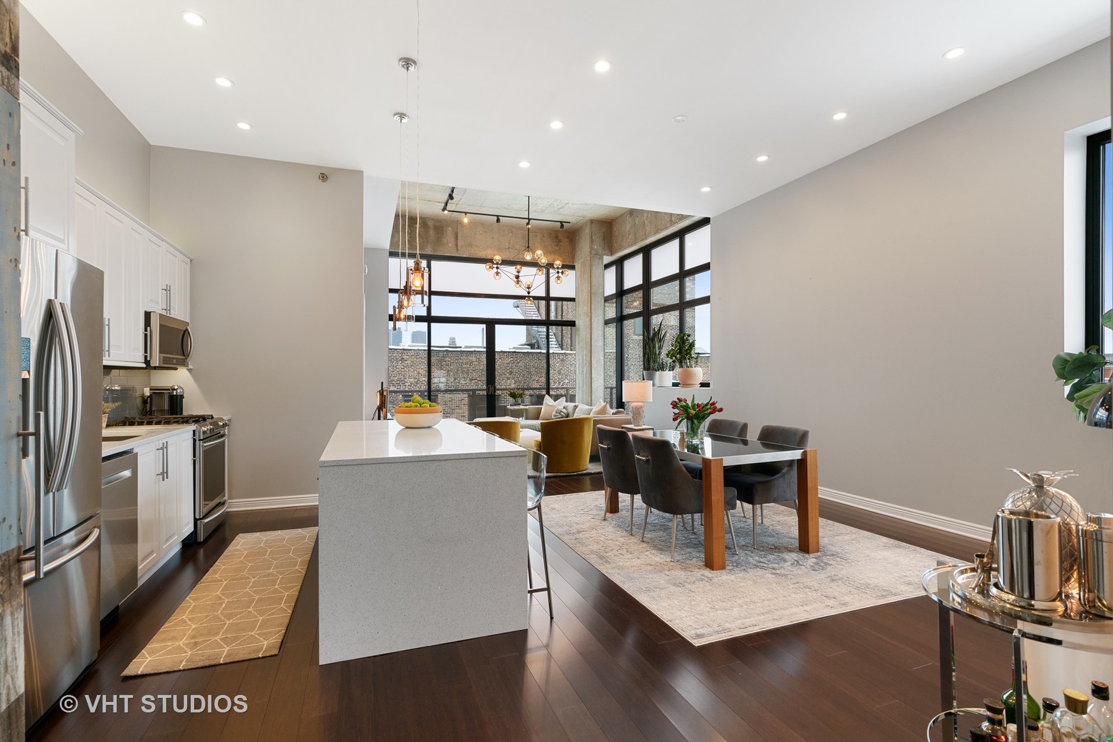 321 South Sangamon Street, Unit 906 Chicago, IL 60607 - Photo 5 of 11 a living room with stainless steel appliances furniture a rug and a kitchen view