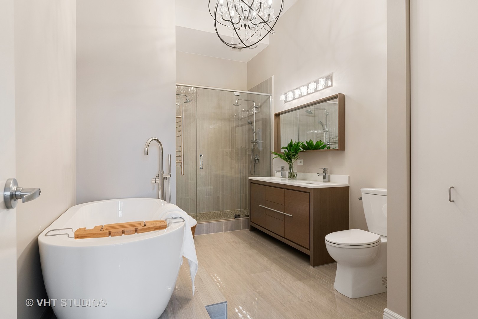 321 South Sangamon Street, Unit 906 Chicago, IL 60607 - Photo 8 of 11 a bathroom with a granite countertop bathtub sink mirror vanity and toilet