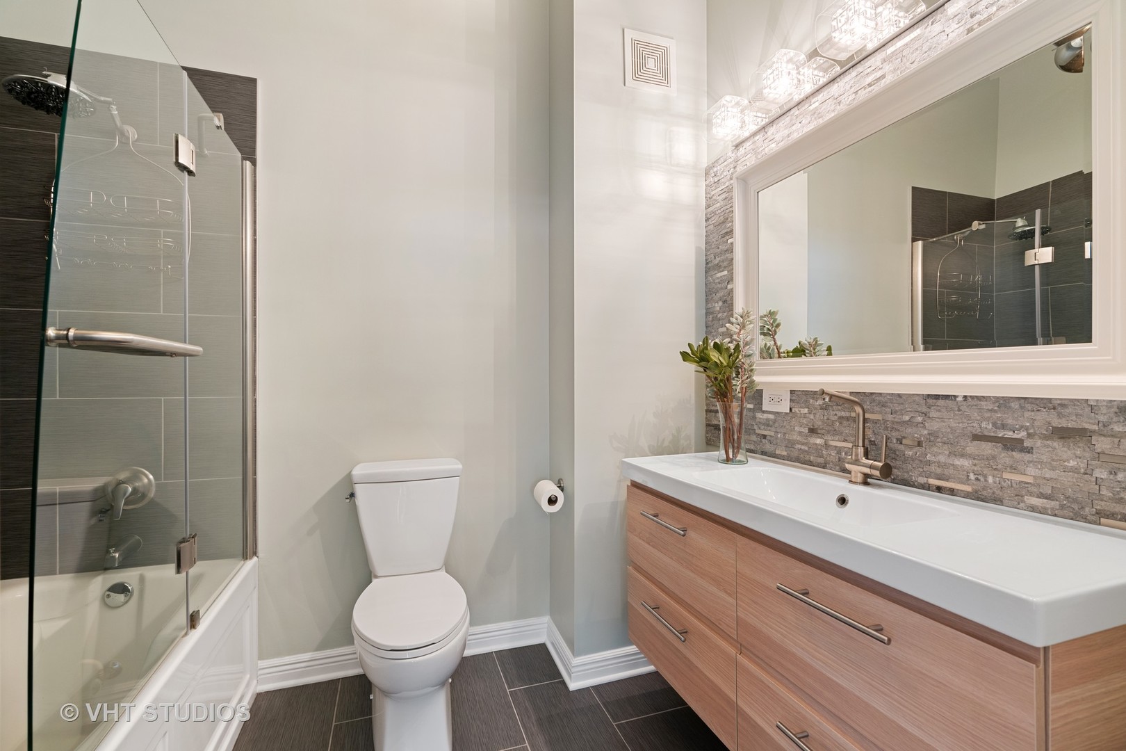 321 South Sangamon Street, Unit 906 Chicago, IL 60607 - Photo 10 of 11 a bathroom with a sink toilet and shower