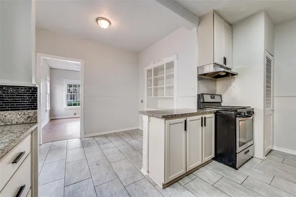 a kitchen with stainless steel appliances granite countertop a stove and a sink