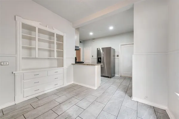 a view of a kitchen with refrigerator and cabinet