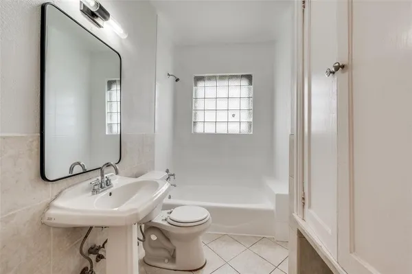 a bathroom with a sink toilet a mirror and shower