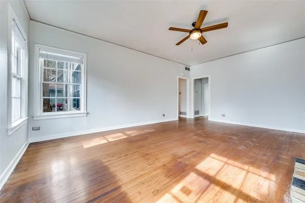 a view of a livingroom with a ceiling fan and wooden floor