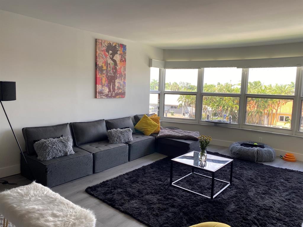 3031 Northeast 51st Street, Unit 305W Fort Lauderdale, FL 33308 - Photo 1 of 11 a living room with furniture and a large window