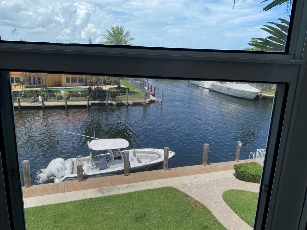 3031 Northeast 51st Street, Unit 305W Fort Lauderdale, FL 33308 - Photo 11 of 11 a view of a balcony with chair and wooden floor