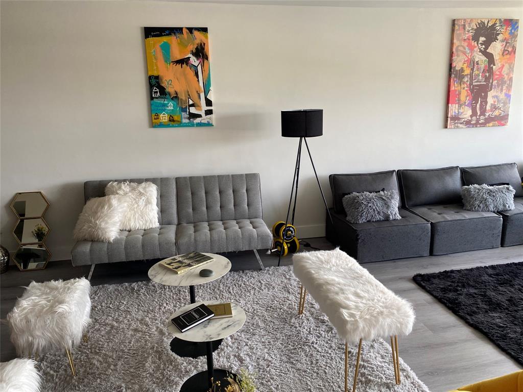 3031 Northeast 51st Street, Unit 305W Fort Lauderdale, FL 33308 - Photo 3 of 11 a living room with furniture and a lamp