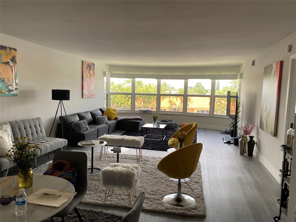 3031 Northeast 51st Street, Unit 305W Fort Lauderdale, FL 33308 - Photo 4 of 11 a living room with furniture or couch and a large window