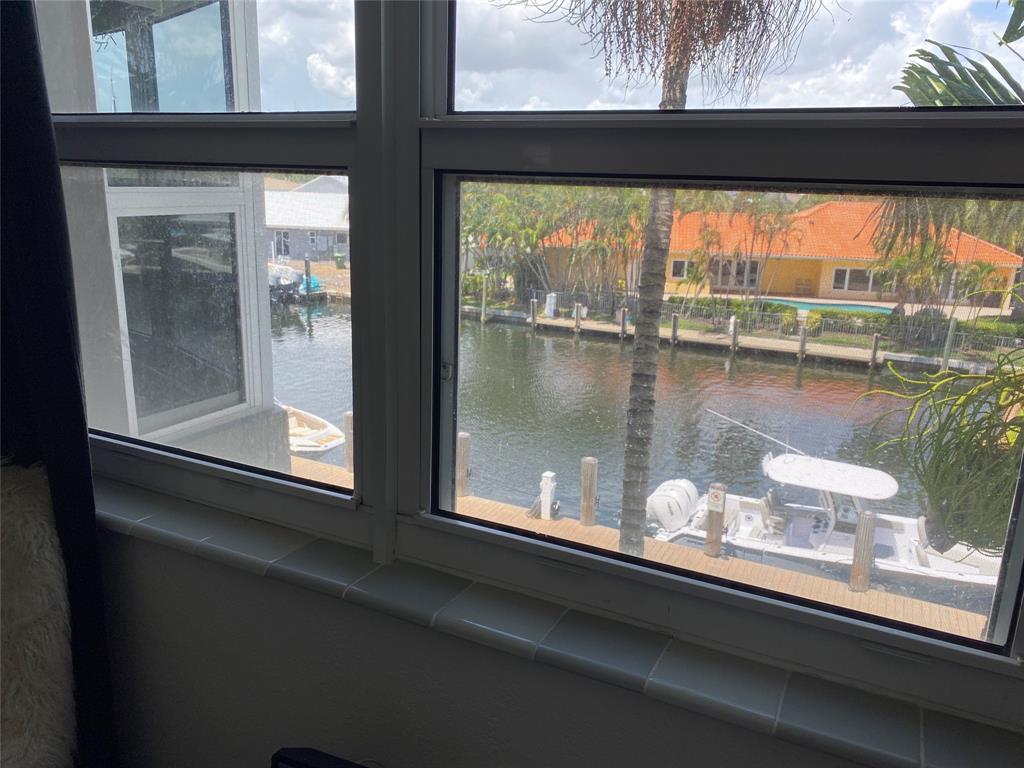 3031 Northeast 51st Street, Unit 305W Fort Lauderdale, FL 33308 - Photo 9 of 11 a view of a lake from a window