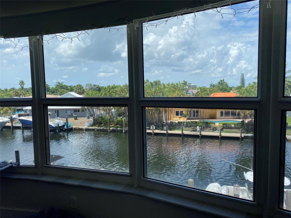 3031 Northeast 51st Street, Unit 305W Fort Lauderdale, FL 33308 - Photo 10 of 11 a view of swimming pool from a window