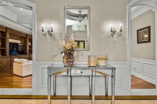 a dining room with furniture wooden floor a rug a potted plant and a chandelier