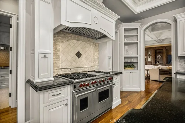 a bathroom with a granite countertop tub sink and mirror
