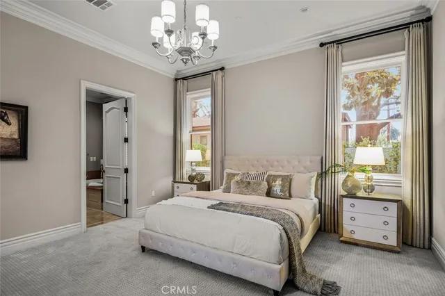 a bed room with a bed and a chandelier
