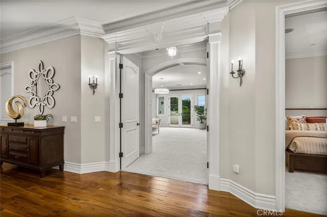 a spacious bedroom with a bed and a chandelier