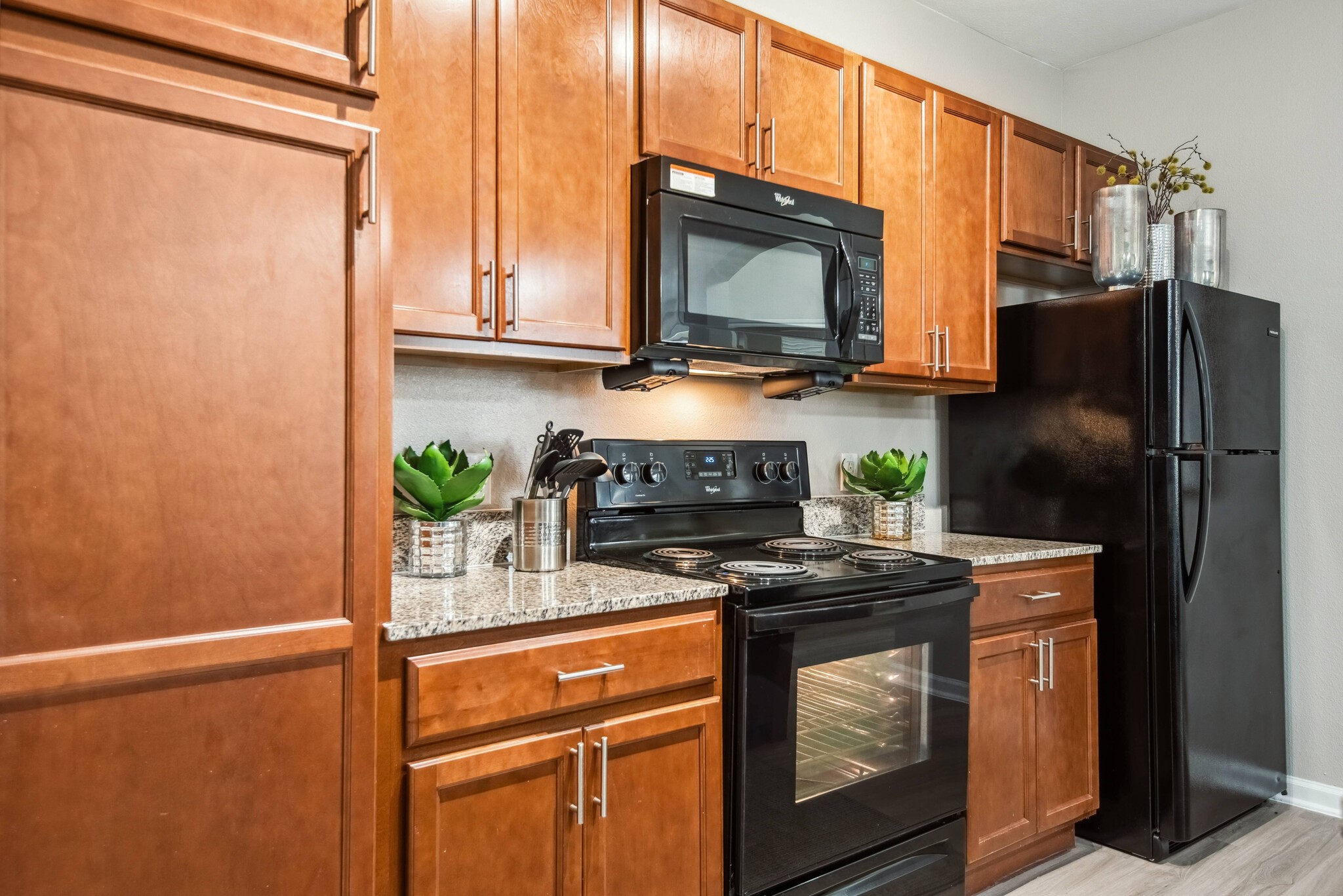 24929 Katy Ranch Road, Unit 9107 Katy, TX 77494 - Photo 3 of 7 a kitchen with stainless steel appliances a stove a microwave and a refrigerator