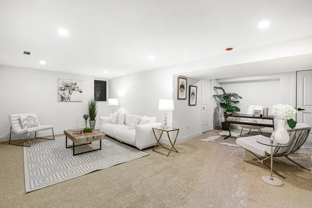 a living room with furniture and white walls