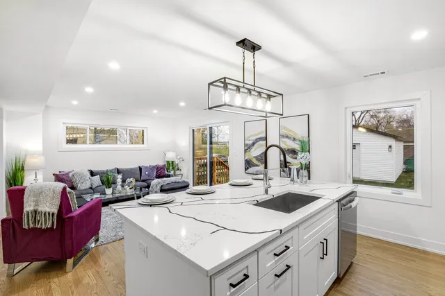 a view of living room with granite countertop furniture and a chandelier