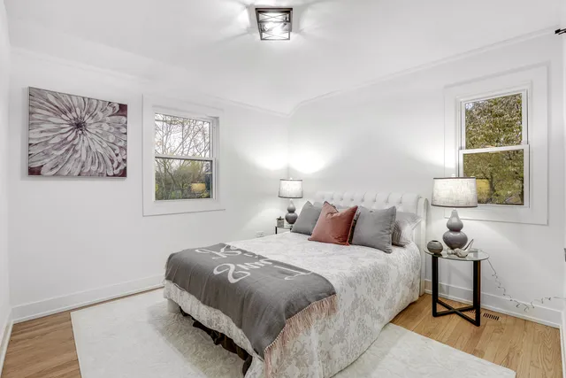 a bedroom with a bed and a lamp on table