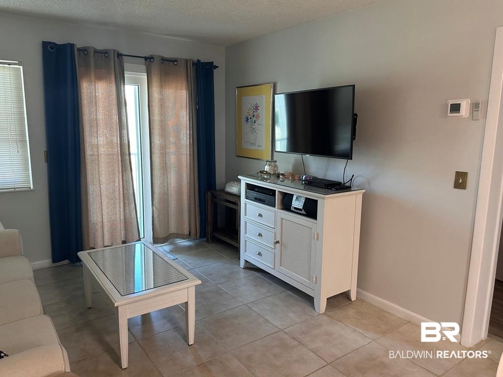 400 Plantation Road, Unit 1113 Gulf Shores, AL 36542 - Photo 5 of 26 Tiled living room with a textured ceiling