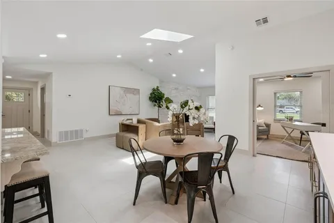 a view of a dining room with furniture and a potted plant