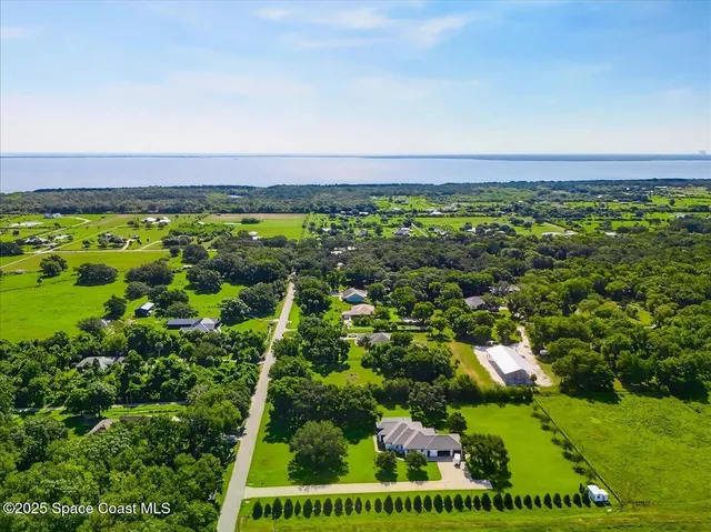 a view of a field with an ocean