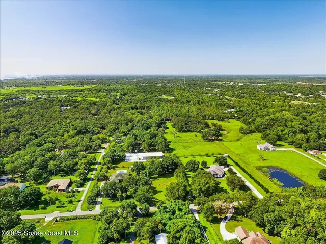 an aerial view of a house with a yard swimming pool outdoor seating and yard