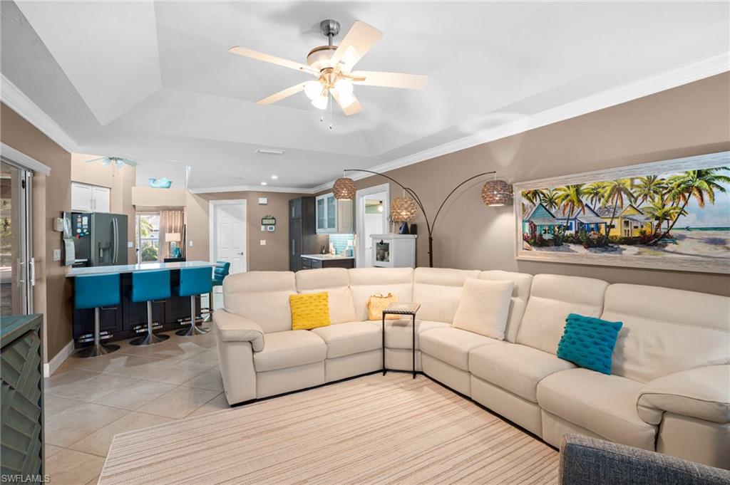 101 Muirfield Circle Naples, FL 34113 - Photo 19 of 27 Family room with tray ceiling offers substantial lighting and natural lighting from sliding glass doors and large windows overlooking pool area.