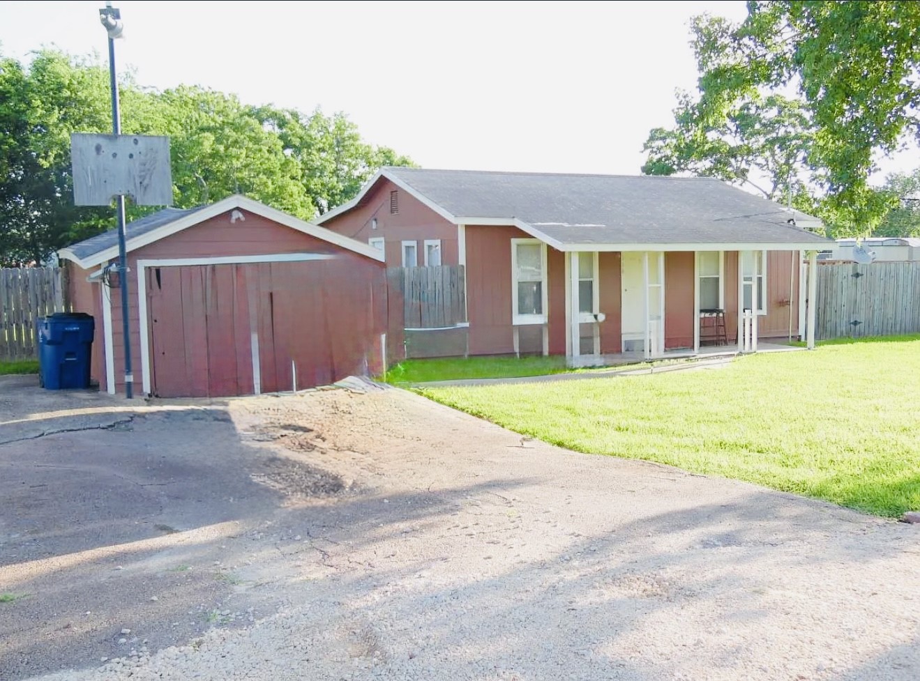 a view of a house with a yard and large tree