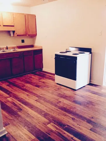 a kitchen with stainless steel appliances granite countertop a sink stove and cabinets