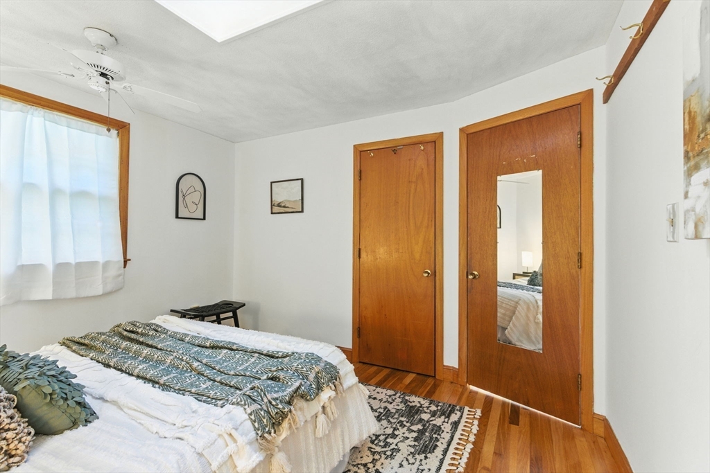 53 Park Street North Reading, MA 01864 - Photo 12 of 24 a bedroom with a bed and a walk in closet