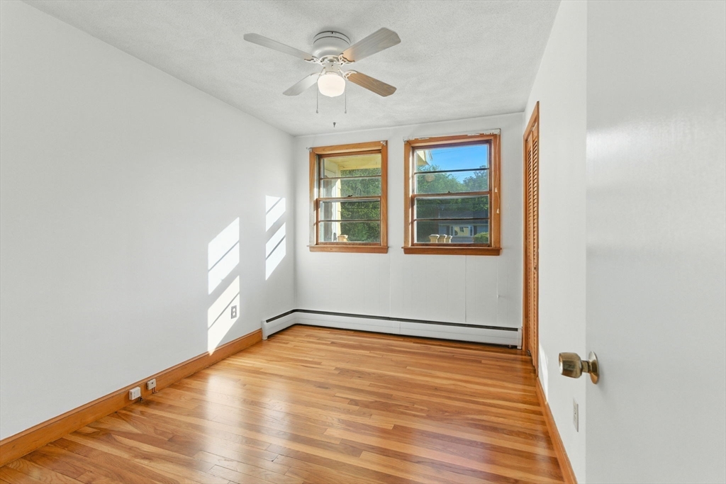 53 Park Street North Reading, MA 01864 - Photo 13 of 24 wooden floor in an empty room with a window