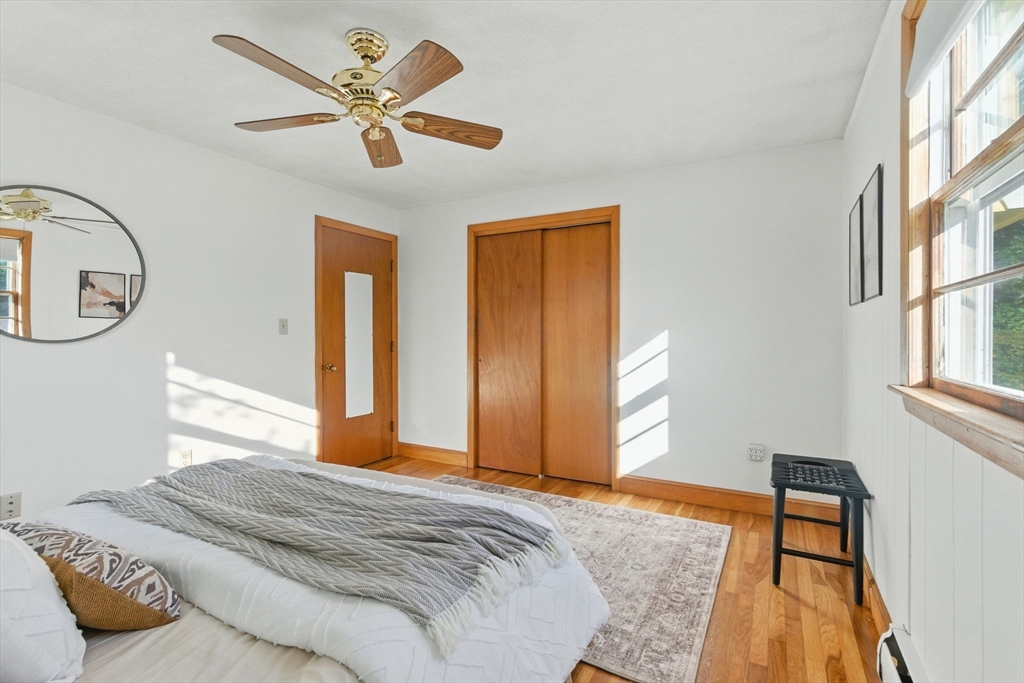 53 Park Street North Reading, MA 01864 - Photo 17 of 24 a bedroom with a bed and a chandelier