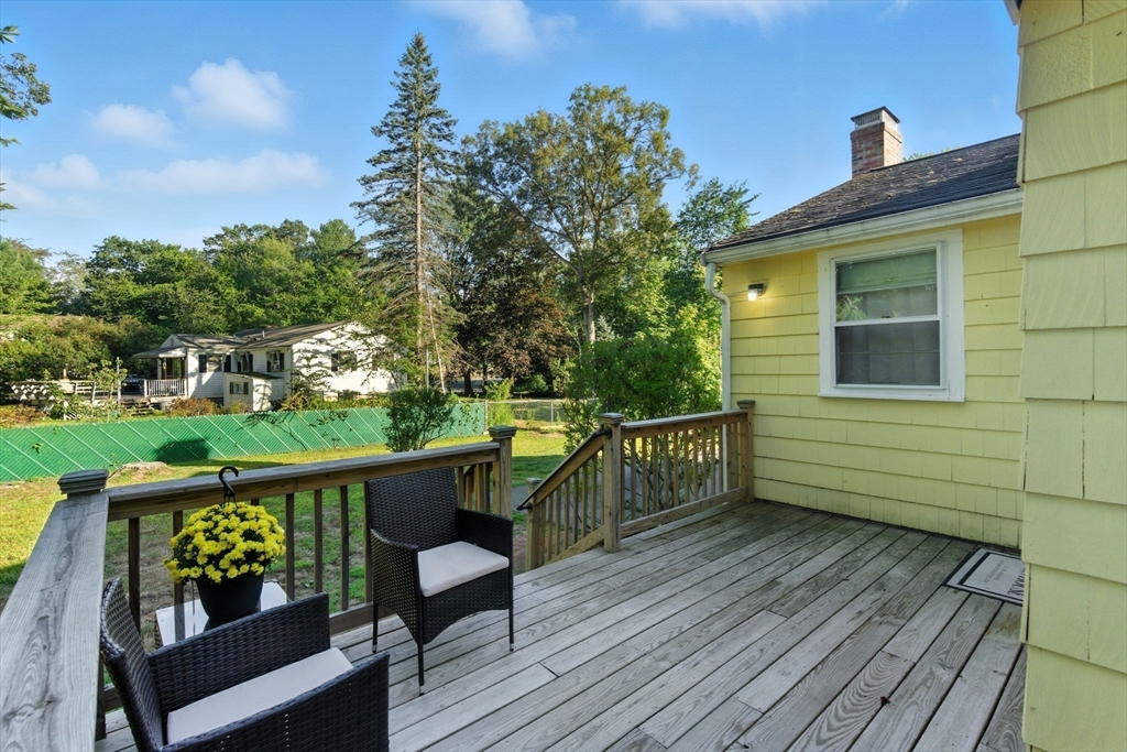 53 Park Street North Reading, MA 01864 - Photo 20 of 24 a view of a deck with two chair and a potted plant