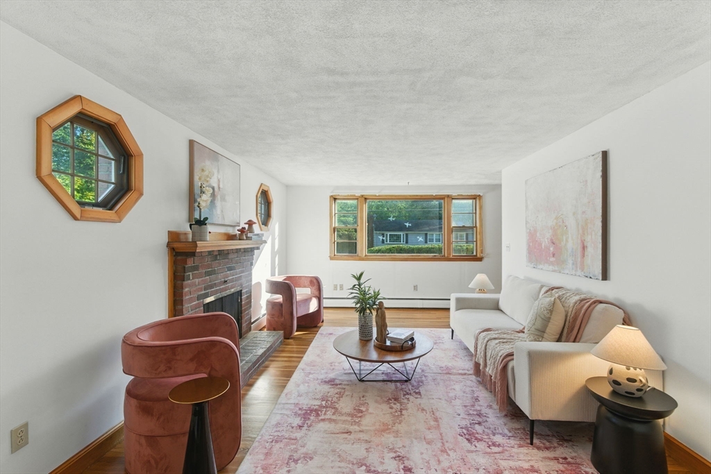 53 Park Street North Reading, MA 01864 - Photo 3 of 24 a living room with furniture a window and a fireplace