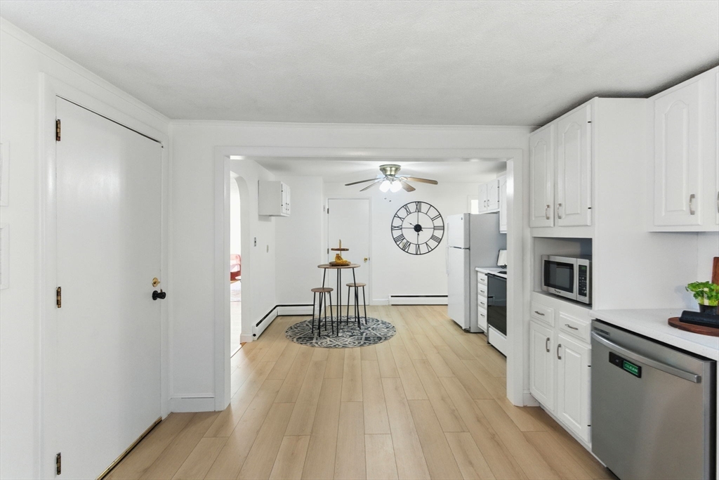 53 Park Street North Reading, MA 01864 - Photo 9 of 24 a kitchen with stainless steel appliances a refrigerator a stove a microwave and cabinets