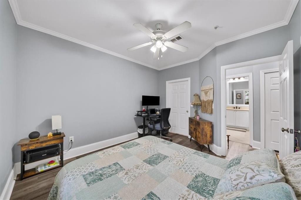 4100 Paces Walk Southeast, Unit 1101 Atlanta, GA 30339 - Photo 22 of 36 a bedroom with a bed and a chandelier
