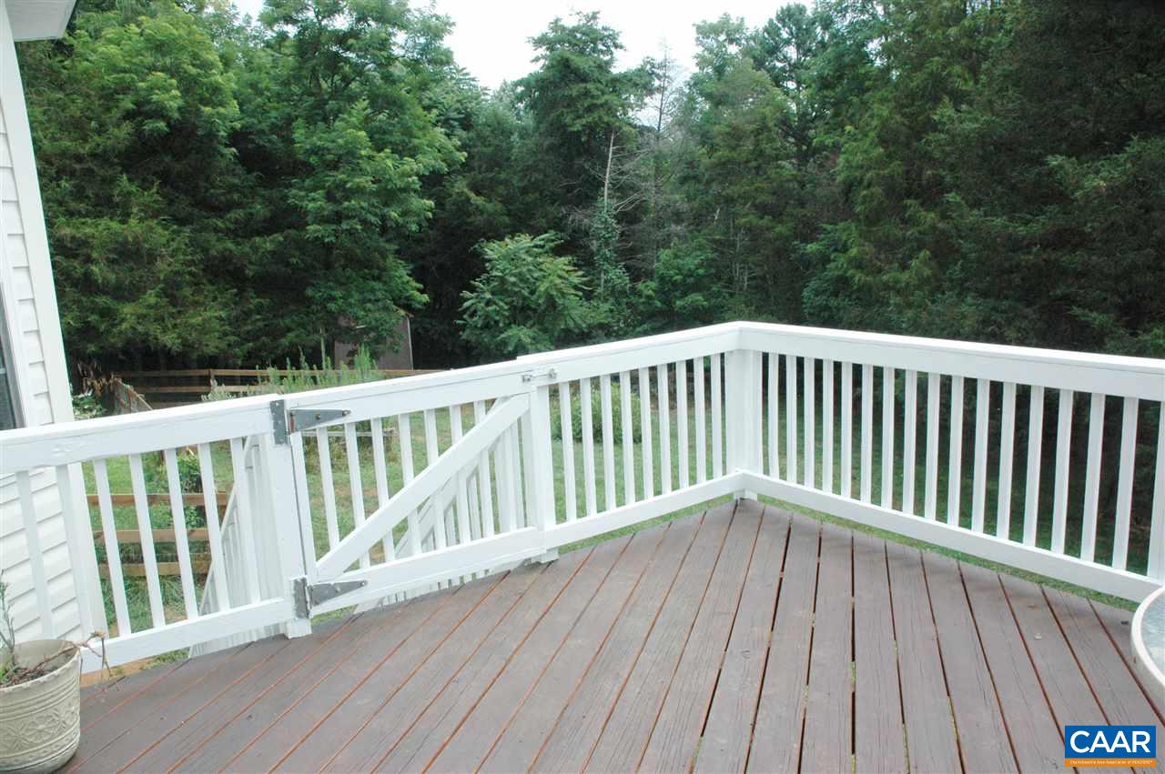 696 Valley View Road Ruckersville, VA 22968 - Photo 19 of 32 a balcony with wooden floor and trees in the back