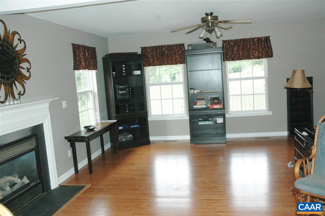 696 Valley View Road Ruckersville, VA 22968 - Photo 4 of 32 a living room with fireplace furniture and a flat screen tv