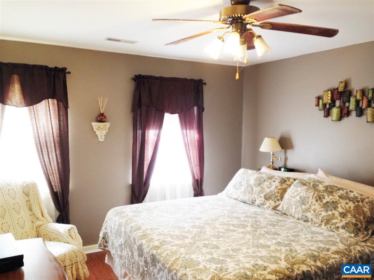 696 Valley View Road Ruckersville, VA 22968 - Photo 9 of 32 a bedroom with a bed and a chandelier