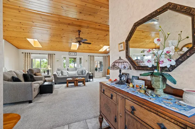 a kitchen with stainless steel appliances granite countertop a refrigerator a stove and a wooden cabinets with wooden floor