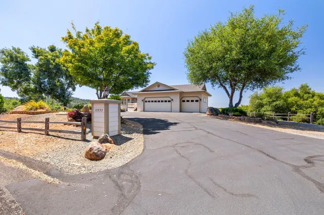 a large tree sitting in front of a house