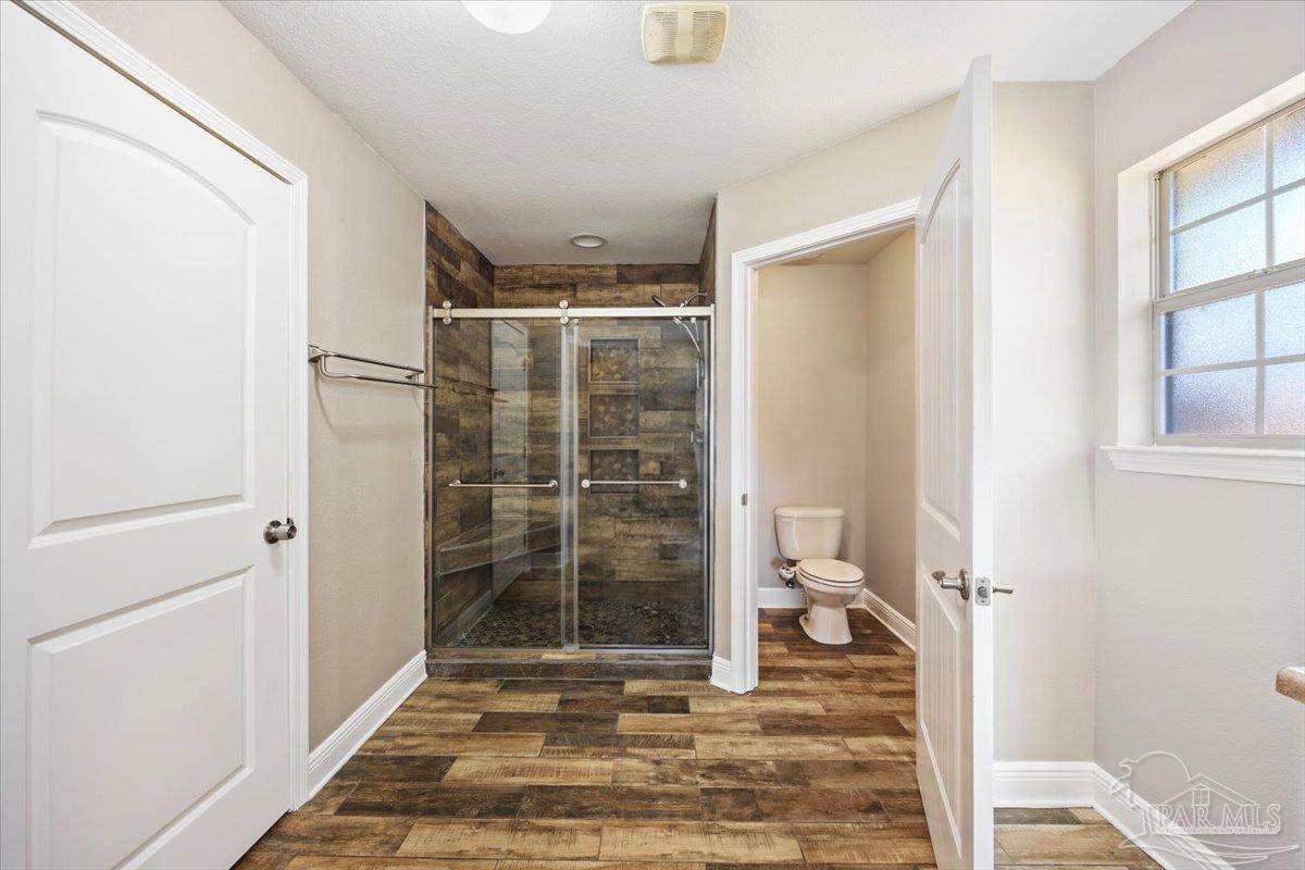 4015 Berry Circle Pace, FL 32571 - Photo 36 of 48 a bathroom with a shower and a toilet