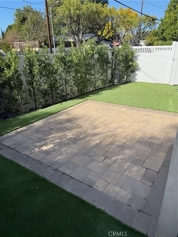 a view of a field of grass and trees