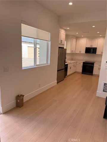 a kitchen with a refrigerator and a microwave