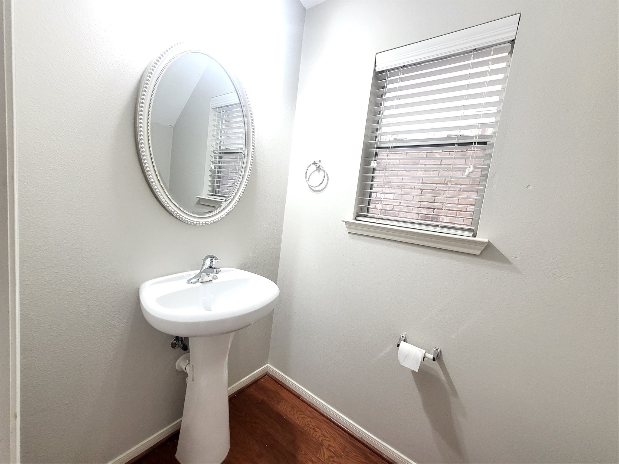 7415 Hollister Ridge Houston, TX 77040 - Photo 14 of 36 a bathroom with a sink a mirror and a window