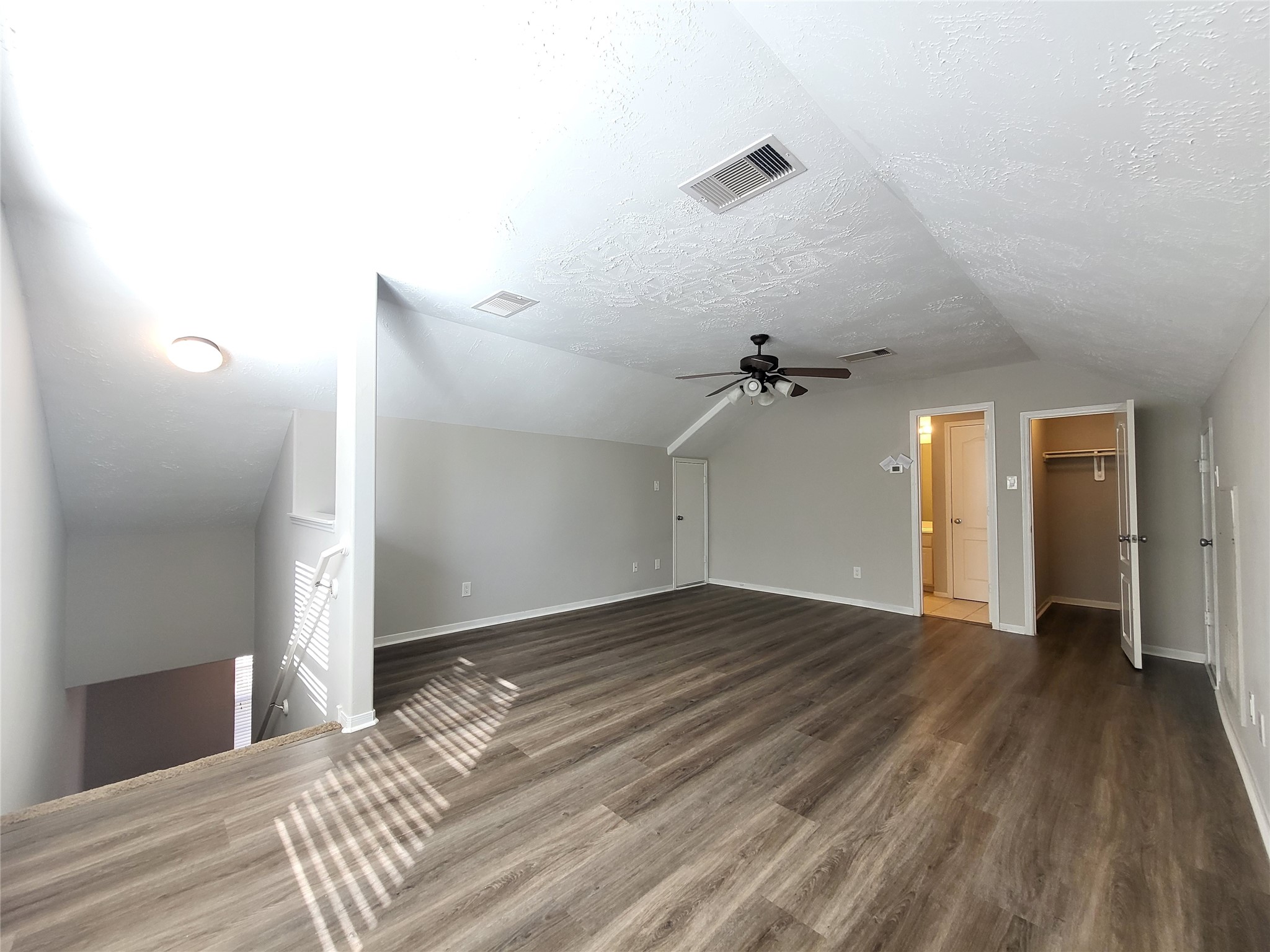 7415 Hollister Ridge Houston, TX 77040 - Photo 35 of 36 a view of a livingroom with wooden floor and a ceiling fan