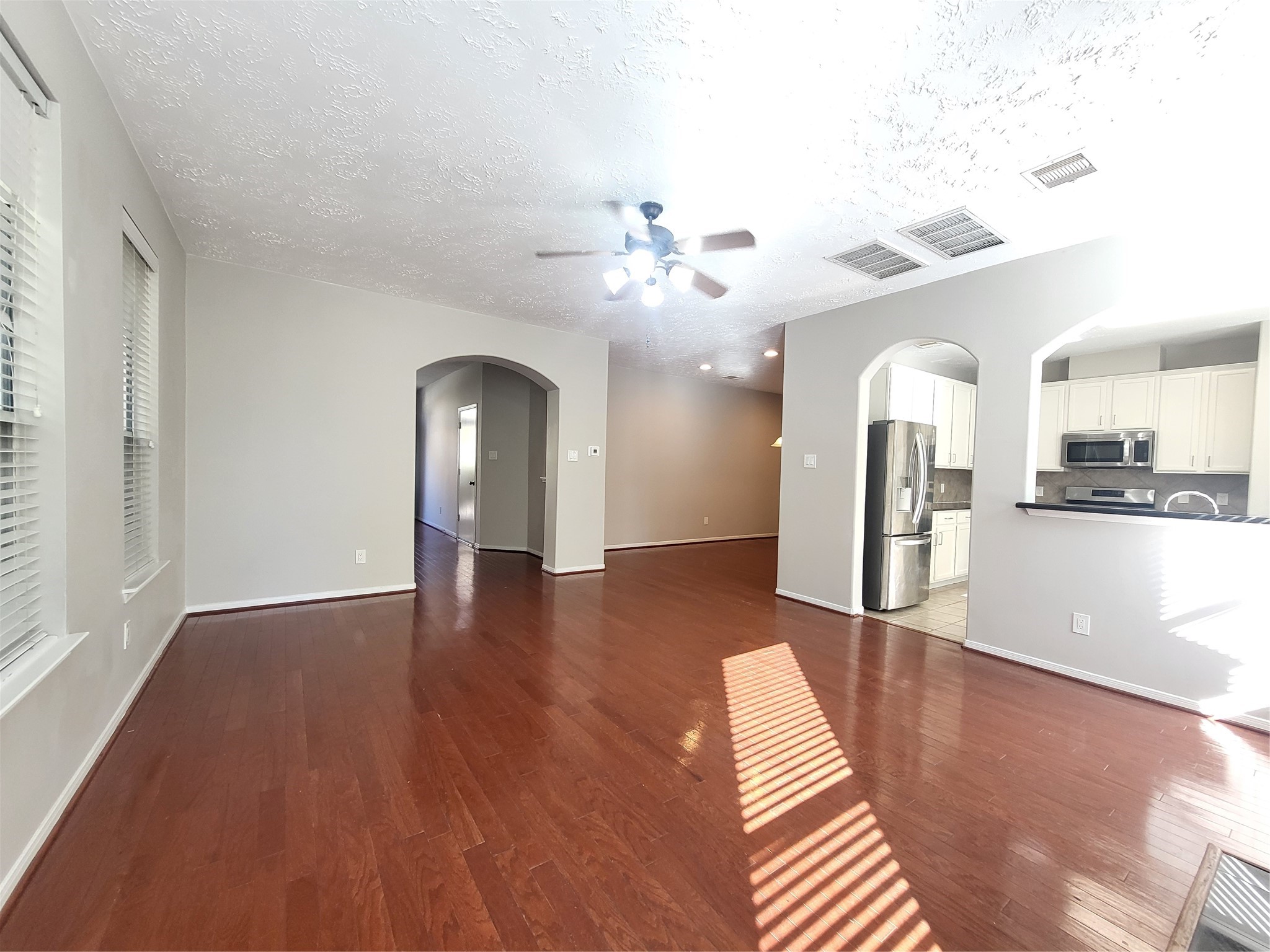 7415 Hollister Ridge Houston, TX 77040 - Photo 6 of 36 a view of a kitchen with wooden floor and a kitchen space with a sink