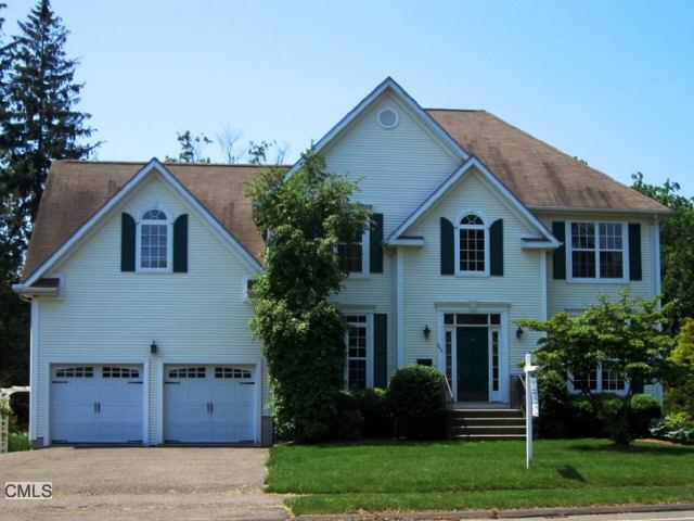 a front view of a house with a garden and plants